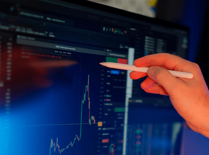 a screen with a graph. And a hand with a stylus pointing at the graph.